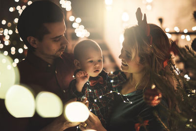 Smiling mother with son in party