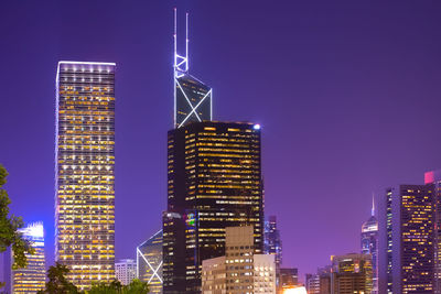 Low angle view of illuminated buildings against sky at night