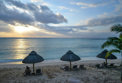 Scenic view of beach against sky during sunset