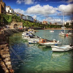 Boats moored at harbor