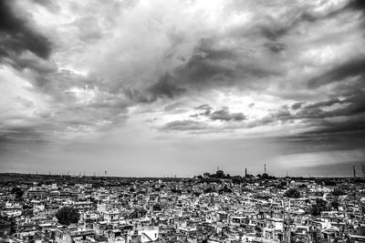 High angle view of cityscape against cloudy sky