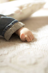Close-up of baby feet on bed
