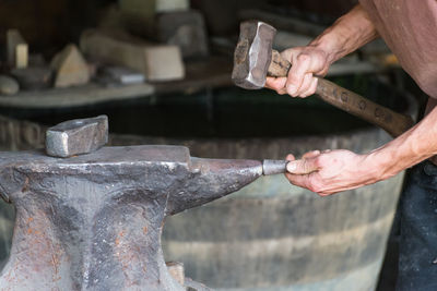 Cropped hands of man working in workshop