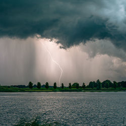 Positive cloud to ground lightning discharge near a lake at dusk