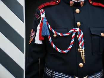 Close-up of man standing against the wall