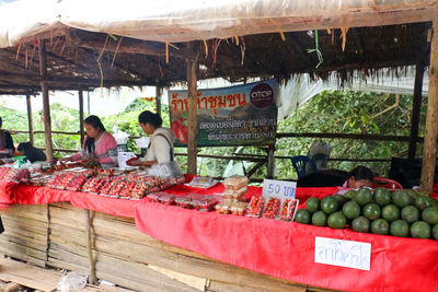 People for sale at market stall