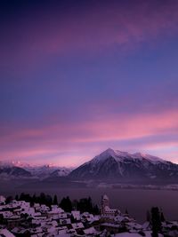 Scenic view of snowcapped mountains against sky during sunset