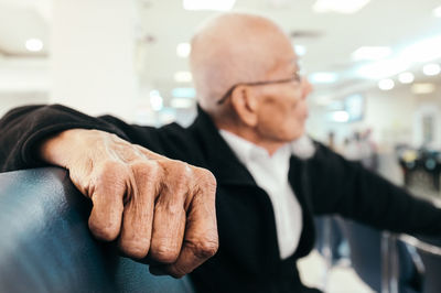 Close-up of senior businessman sitting on seat