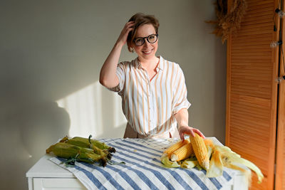 Woman holding food on table at home