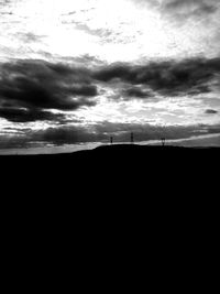 Scenic view of silhouette land against sky at sunset