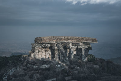 Old ruins of building against cloudy sky