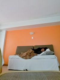 Man lying down on bed at home