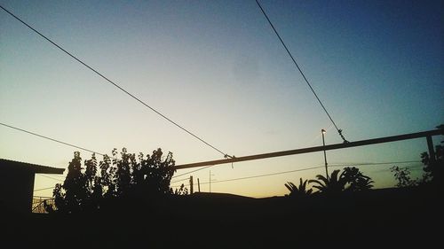 Low angle view of silhouette trees against sky during sunset