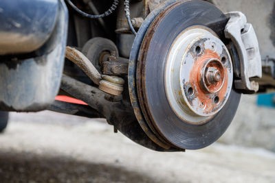 The hub of the front wheel of a jacked car during a tire change