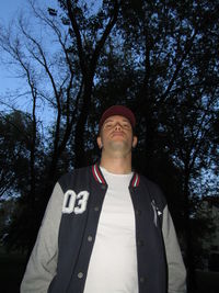 Low angle view of man standing against trees