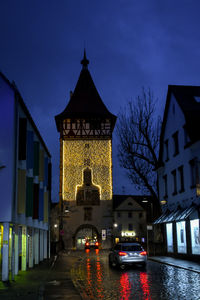 Illuminated building against sky at dusk