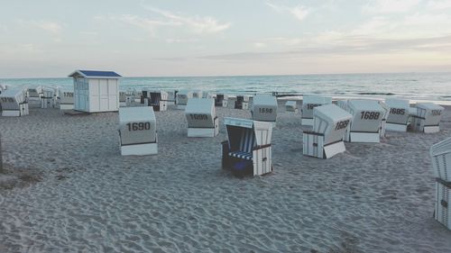 Empty lounge chairs on sandy beach