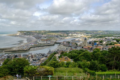 High angle view of buildings and sea against sky