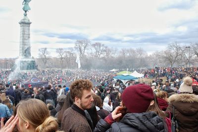 Group of people looking at city against sky