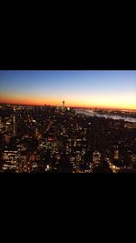 Aerial view of city lit up at night