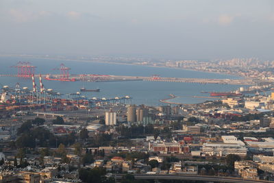 High angle view of townscape by sea against sky