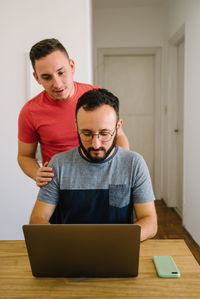 Two men looking at a laptop.