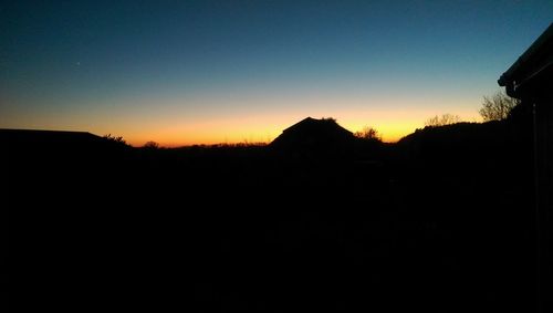 Scenic view of silhouette mountains against sky at sunset