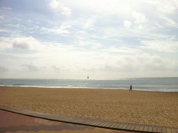 Scenic view of sea against cloudy sky