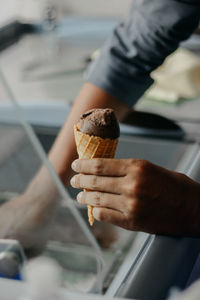 Close-up of hand holding ice cream cone