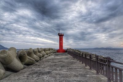 Lighthouse against cloudy sky