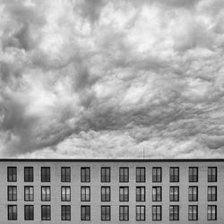 Low angle view of building against cloudy sky