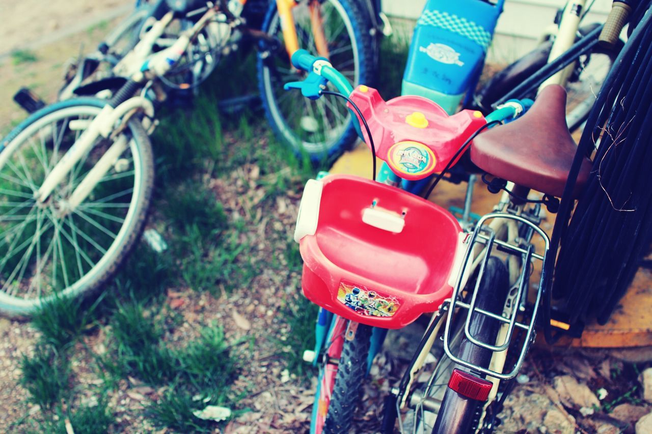 bicycle, land vehicle, mode of transport, transportation, stationary, metal, variation, day, high angle view, parked, parking, wheel, multi colored, outdoors, close-up, no people, focus on foreground, part of, abundance, motorcycle