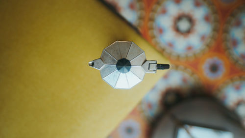 Low angle view of electric lamp against wall at home