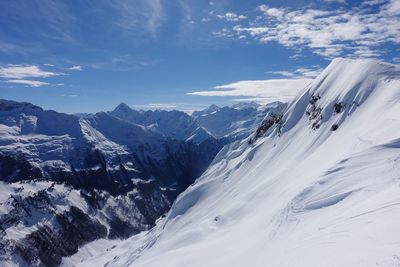 Scenic view of snow covered mountains against sky