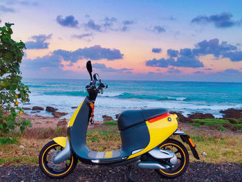 Motorcycle on beach against sky