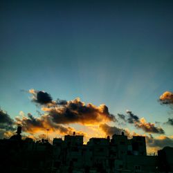 Low angle view of building against sky at sunset