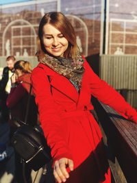 Portrait of smiling young woman sitting outdoors