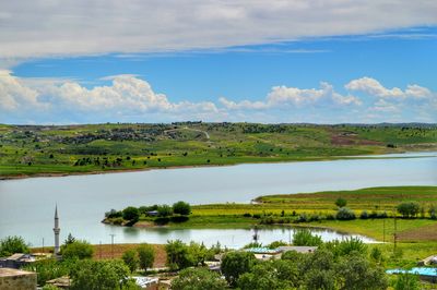 Scenic view of lake against cloudy sky