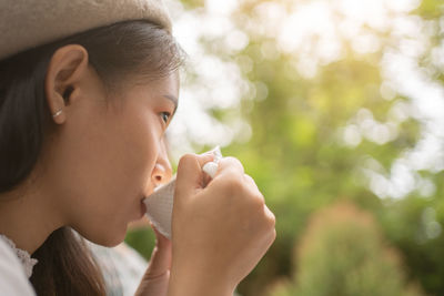 The girl in the cafe, a beautiful young woman in a cafe enjoying the taste of the drink.