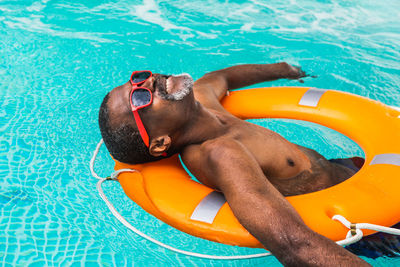 Low section of woman swimming in pool