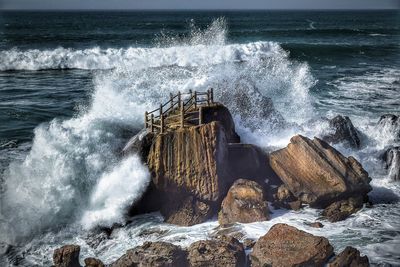 Water splashing on rocks during sunny day