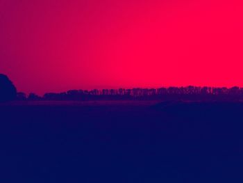 Scenic view of silhouette landscape against clear sky during sunset