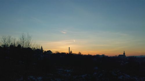 Silhouette trees against sky during sunset