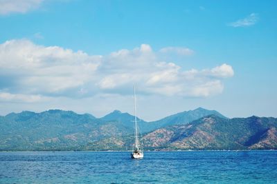 Sailboat sailing on sea against sky