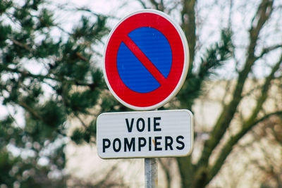 Close-up of road sign against trees