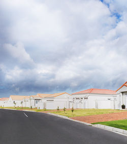 Houses on field against sky