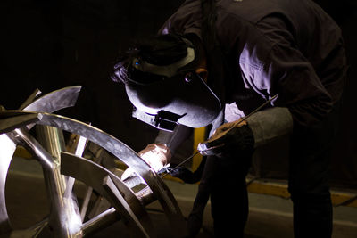 Man welding metal at factory