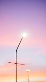 Low angle view of street light against sky during sunset