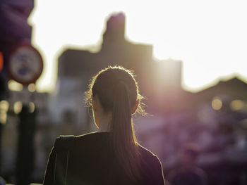 Rear view of woman walking in city