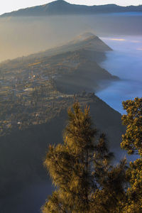 High angle view of city by sea against sky